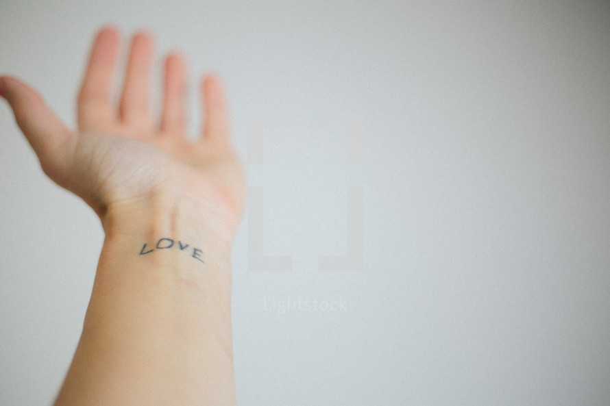"Love" tattoo on a wrist.
