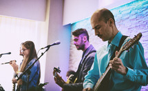 worship leaders playing music on stage 