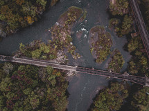 aerial view over a train bridge over a river 