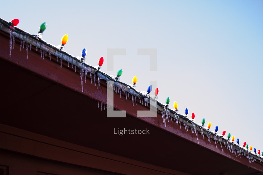 Christmas lights and icicles on a gutter
