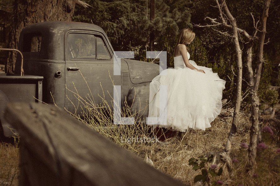 a bride sitting on an old truck classic country wedding marriage 