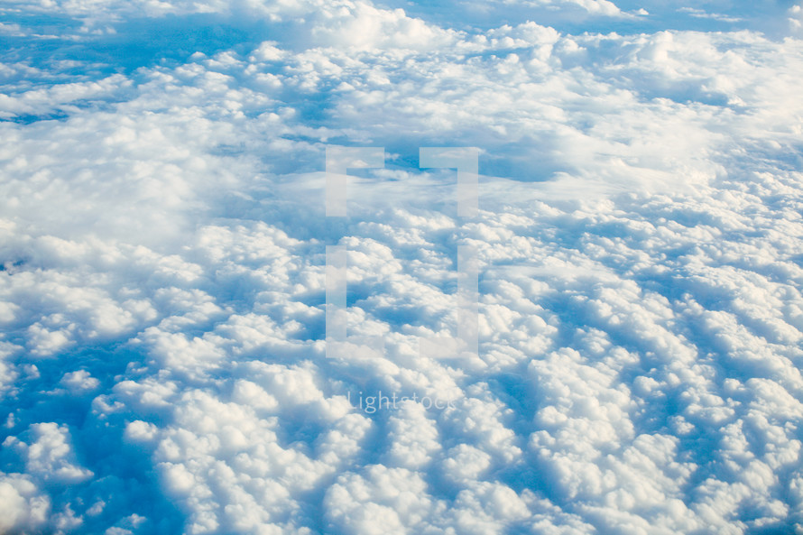 above the clouds in a blue sky