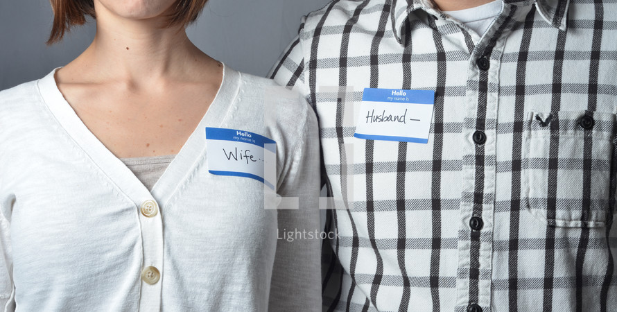 man and woman wearing name tags that read husband and wife