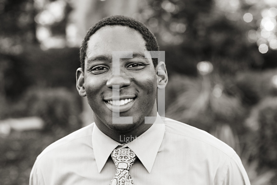 A smiling young man in a shirt and tie African American 