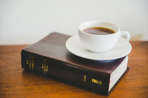 coffee cup on a Bible 