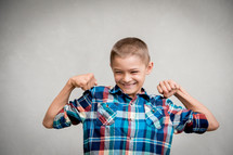 kid showing his muscles 