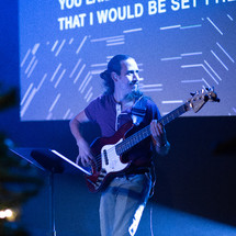 man playing a guitar on stage 