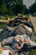 Debris on the side of a road, cleaning up after a flood 