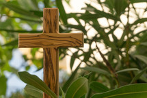wooden cross in a bush 