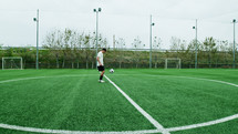 Teenager Does Freestyle Soccer Dribbles In The Field