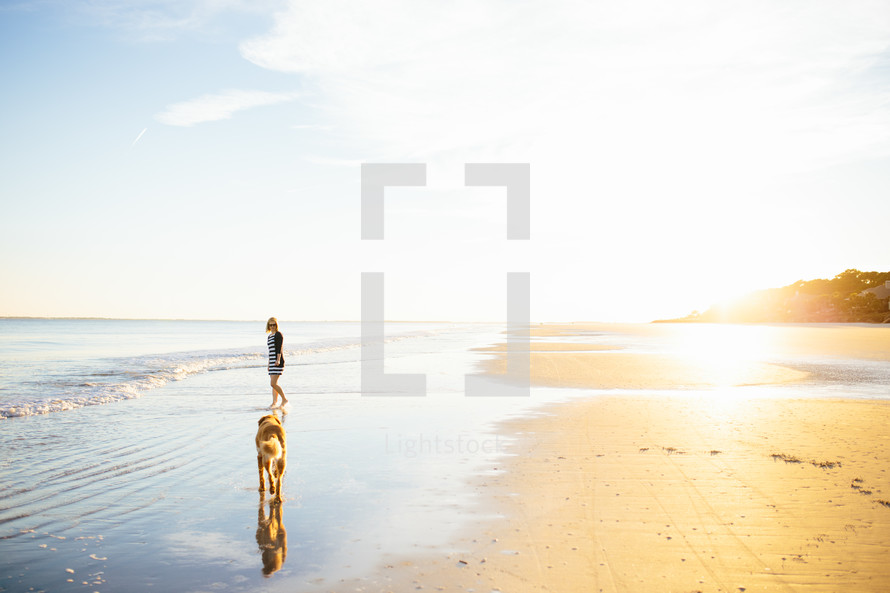 boy and dog on a beach 