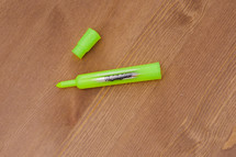 cap off a highlighter on a table 