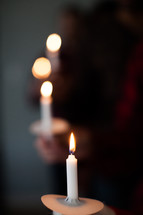 People holding candles at a candlelight service