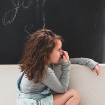 girl in front of a wall painted with chalkboard paint 