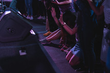 sitting on the floor in prayer during a worship service 