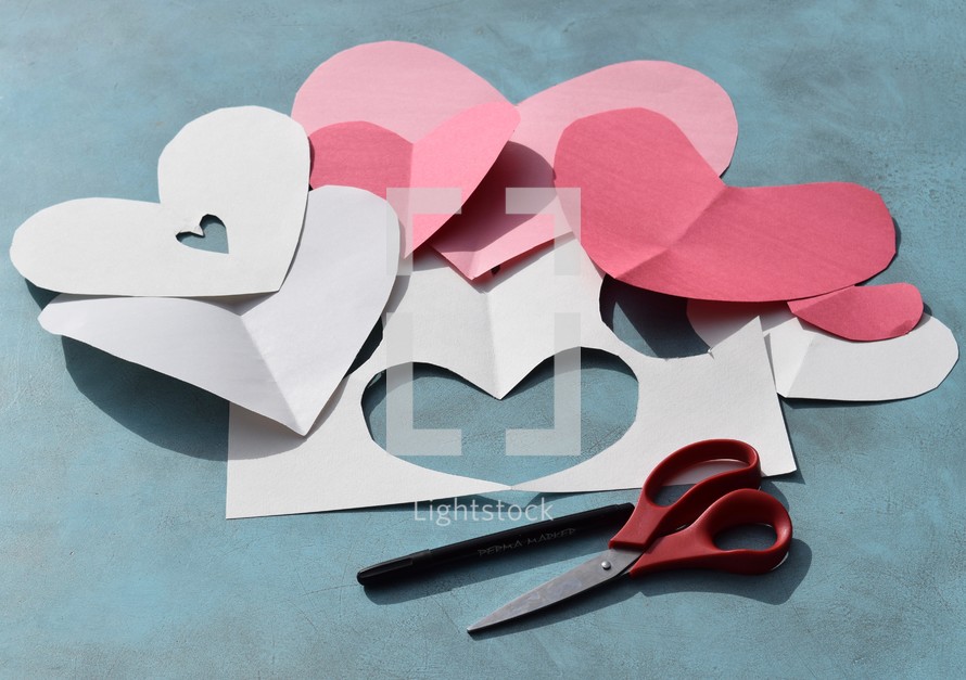 construction paper, scissors, and marker to make homemade Valentine's day cards