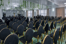 Chairs set up for wedding with greenery 