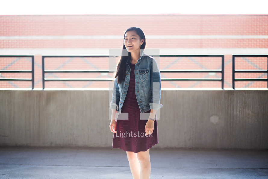 portrait of a young Asian woman standing in a parking garage 