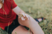a girl sitting in grass