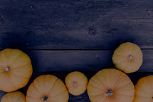 Fall, harvest, pumpkins on dark wood background, border, frame,  Horizontal