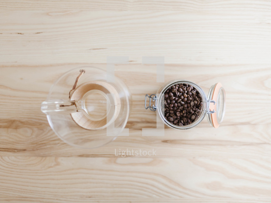 overhead view of a pitcher of water and coffee beans 