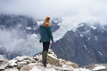 a woman standing on a mountaintop 
