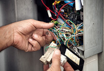 Electrician repairing electric system of an automatic gate