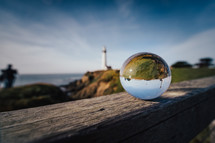 glass orb and lighthouse 