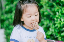 a toddler girl eating ice cream 