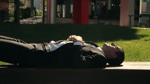 businessman resting in sunlight 