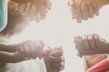 holding hands in a prayer circle 