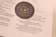 compass on the pages of a Bible