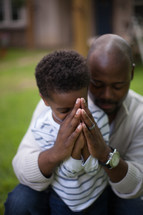 father and son praying together 