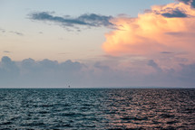 clouds over a calm ocean at sunrise 