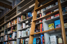 a ladder against a bookshelf 