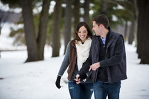 couple walking outdoors in the snow 