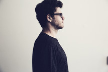 side profile of a man wearing glasses 