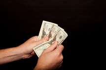 hands holding cash 