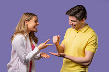 Positive funny couple playing rock paper scissors. Settling dispute method, decision. Rochambeau team games. High quality