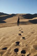 a woman exploring sand dunes 