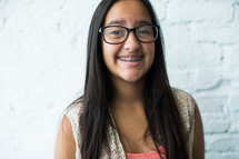 latino teen girl with braces smiling 