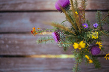 wildflowers in a vase on picnic table 