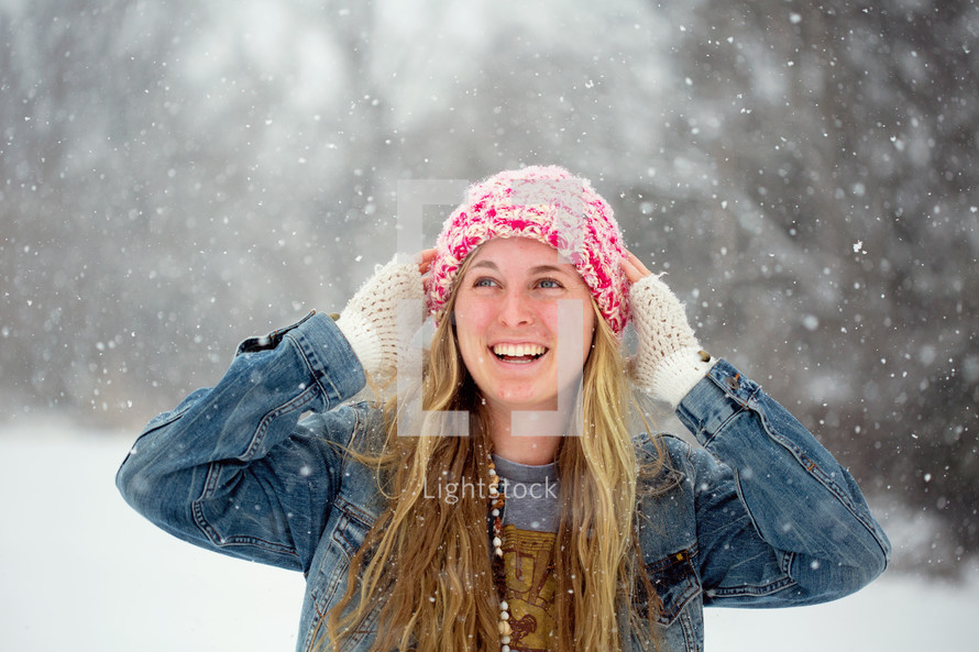 snow falling outdoors on a woman 