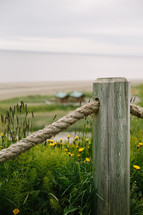 rope fence near dunes on a beach 