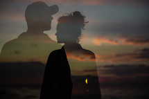 silhouettes of a man and a woman at sunset 