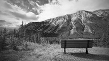 a bench facing a mountain 