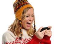 woman in winter hat texting on her cellphone 