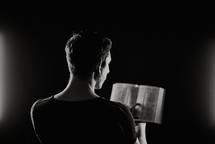 a man reading from a Bible 