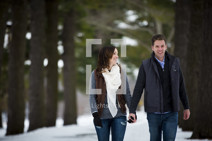 couple walking holding hands outdoors 