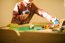 a toddler boy playing with a toy train 